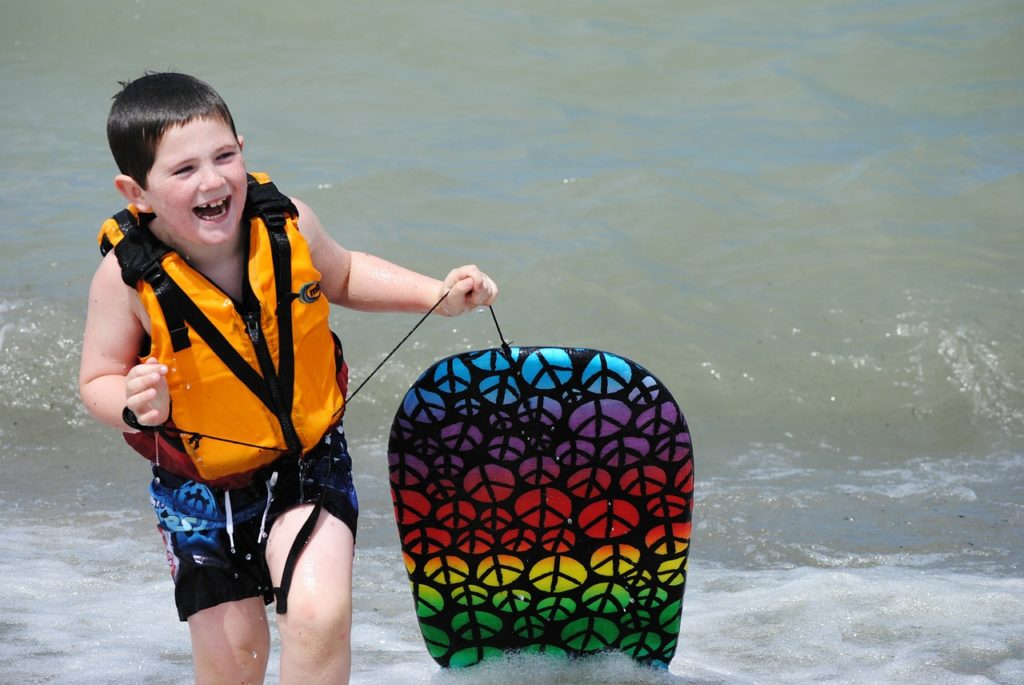 Boy at sea with swimming board