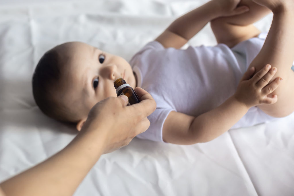 Happy baby with medicine