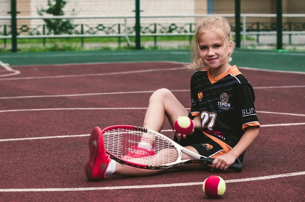 Girl with tennis racket and balls