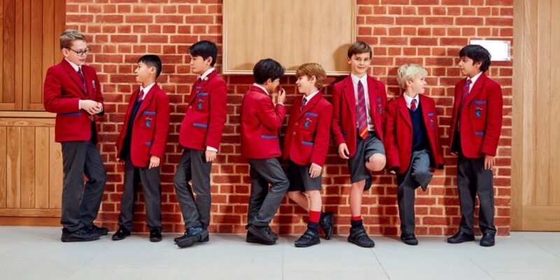 Kings Primary student standing against the wall in uniform