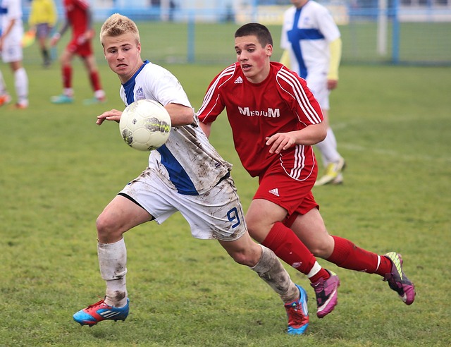 2 boys playing football