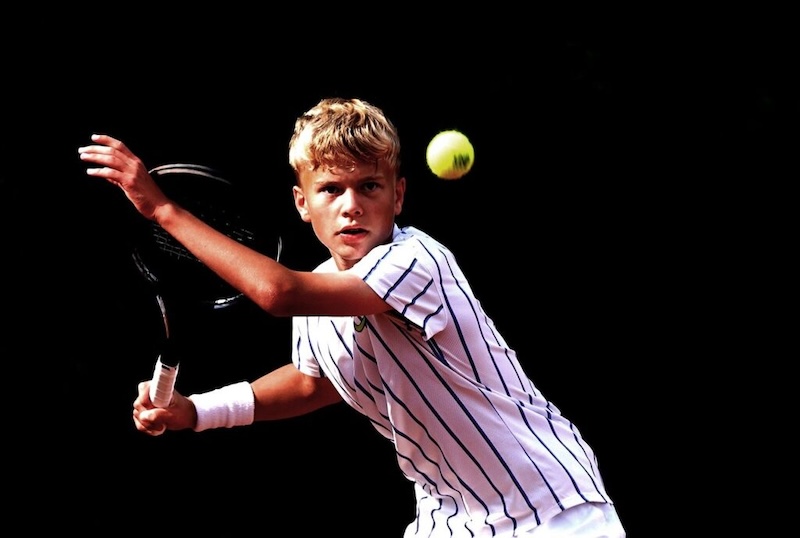 Boy teen playing tennis